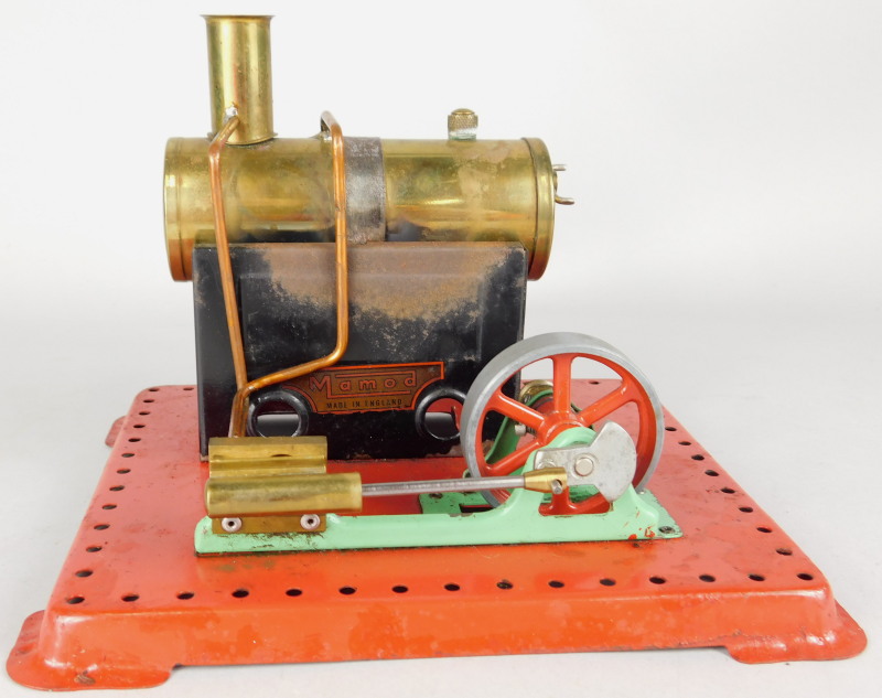 A Mamod stationary engine, on a red painted base