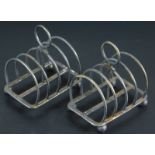 Two similar George V small silver four division toast racks, each with ball feet, one lacking,