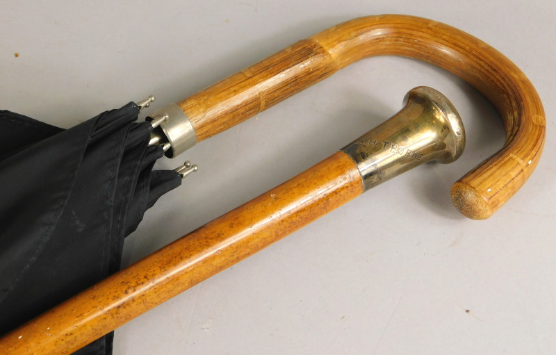 A malacca walking cane, engraved A H Thorne, with silver collar, and an umbrella