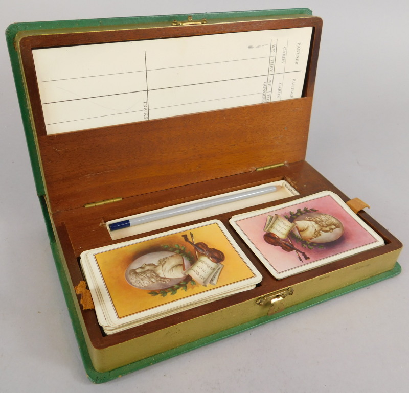 An early 20thC leather bridge box, containing playing cards, scorers etc.