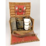 A late 19th/early 20thC picnic hamper, with various fittings to include a brass and copper kettle