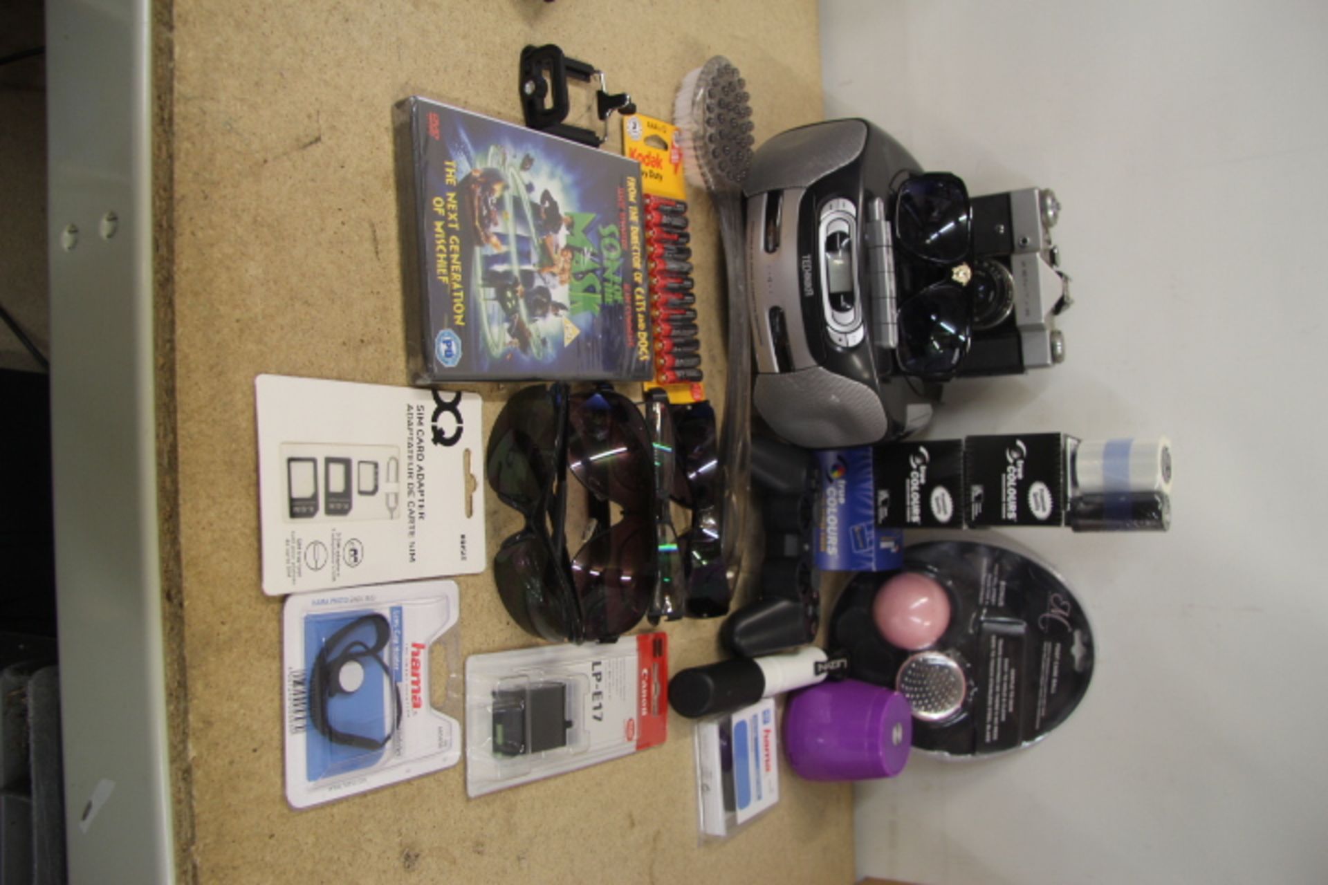 Grade U A Box Containing Misc. Items Including A Camera - A Game Controller - Batteries - Saucepans
