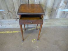 A mahogany bedside table on cabriole legs