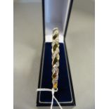 A 9ct Gold Bangle set with diamonds - total weight 9.8g