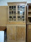 An antique pine dresser with 2 cupboards under and glazed doors above.