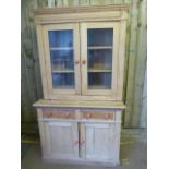 A Pine dresser with glazed cabinet over