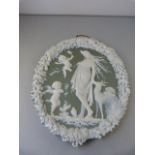 A Green and White Jasperware style plaque of Cherubs and a lady