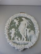 A Green and White Jasperware style plaque of Cherubs and a lady