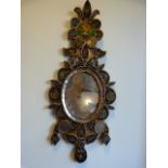 An ornamental mirror with handpainted panels