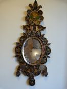 An ornamental mirror with handpainted panels