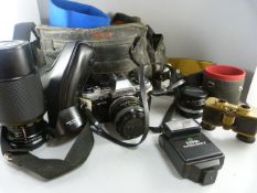 An Olympus Camera in bag with two additional lenses and strap and a pair of vintage opera glasses