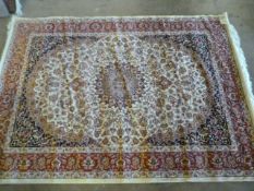 A Beige ground Keshan carpet 1.90 x 1.40