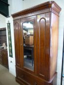 A victorian Mahogany wardrobe with mirrored door