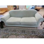 A Light Green two seater sofa