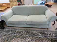 A Light Green two seater sofa