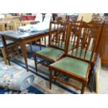 A dining room table and 4 chairs with glass top