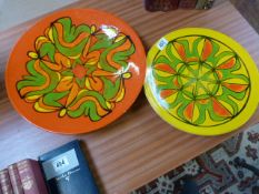 A Poole Pottery 'Delphis' Charger on bright yellow background shape 5. along with another Poole