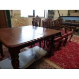 A Victorian mahogany extending table with extra leaf and 6 chairs