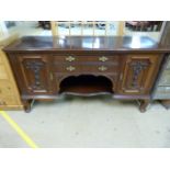 A Large mahogany sideboard with carved foliate panels and three drawers C. Edwardian