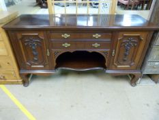 A Large mahogany sideboard with carved foliate panels and three drawers C. Edwardian