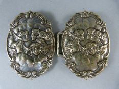 Silver belt buckle (possible nurses) depicting angels in clouds. Hallmarks visible but faded.