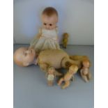 An Armand Marseille Bisque headed Doll (head A/F) and one other, plus four smaller dolls