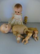 An Armand Marseille Bisque headed Doll (head A/F) and one other, plus four smaller dolls