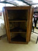 An Antique pine corner cupboard