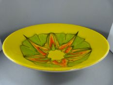 A Poole Pottery 'Delphis' Bowl - shape 58 on a bright yellow background