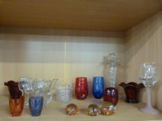 A quantity of coloured glass to include three paperweights