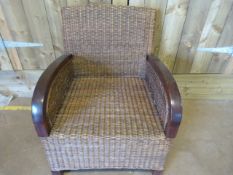A Large wicker chair on mahogany frame