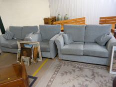A Turquoise fabric suite - consisting of two settees and one armchair