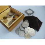 A small quantity of various coins in a box