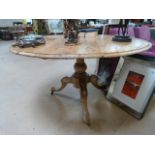 A round pine pedestal table