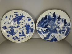 A pair of Japanese blue & white plates/chargers - 1 depicting Japanese artefacts and the other a