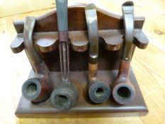 A quantity of wooden pipes and stand