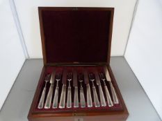 A 24 piece Hallmarked Georgian Silver canteen of cutlery in Mahogany Box