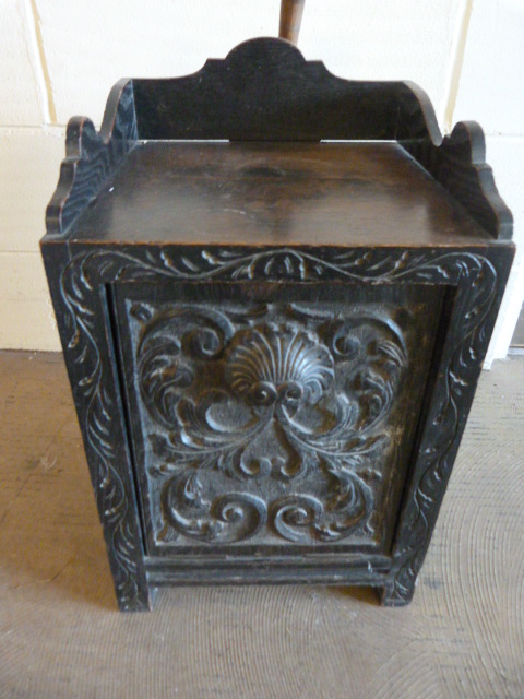 A Carved oak Victorian coal scuttle with spade to back