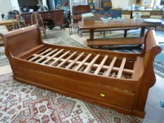 A Single sleigh bed with Roll out bed under