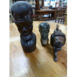 An African carved figure of a lion along with Stone carved tribal man and a wooden carved tribal