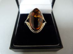 A Silver Ring set with an approx 20mm x 10.3mm oval Amber Stone Size Q (UK) 8 (USA)