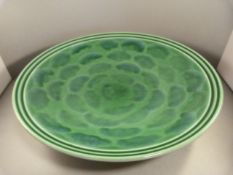A Poole Pottery charger with green Iridescent glaze by Nikki Massarella