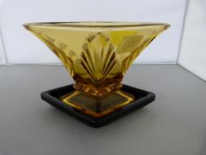 An Art Deco Amber vase on black dish