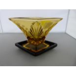 An Art Deco Amber vase on black dish