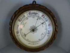 An oak Aneroid barometer with carved rope decoration