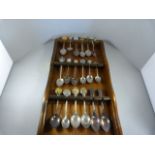 A small quantity of silverplated collector teaspoons on stand
