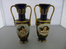 A Pair of Berlin Two handled Urns with hand-painted foliate Gilt decoration