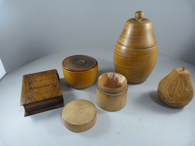 A Treen pot in the form of a pear, two other similar pots and trinket holder in the form of a