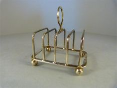 A hallmarked silver miniature toast rack assayed in Sheffield dated 1931 by Henry Atkin - total