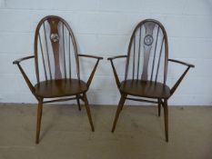 A pair of Ercol Chairs with Swan Decoration
